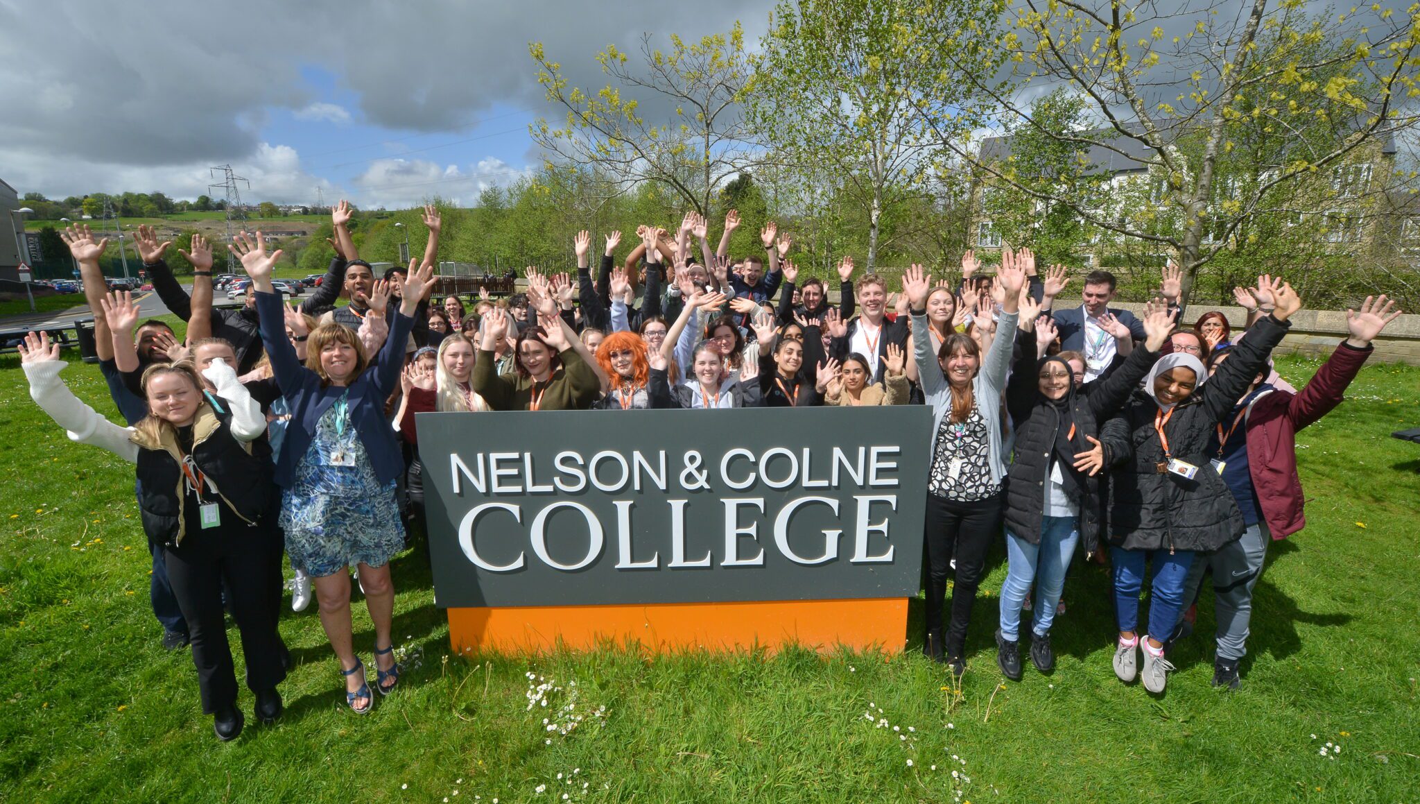 Photo of students and staff from Nelson and Colne College Group celebrating their recent 'Outstanding' Ofsted rating